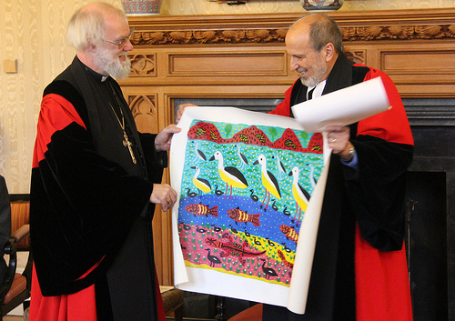 The Revd Dr John Harris presents the Archbishop with Aboriginal artwork