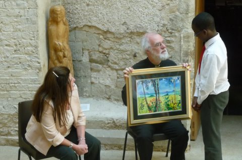 School of the Resurrection student Success Anyanwu presenting his painting to the Archbishop